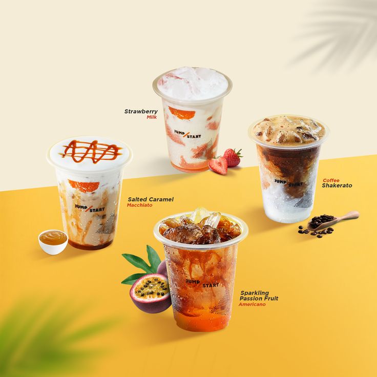 three different types of ice creams on a yellow surface with palm leaves and strawberries