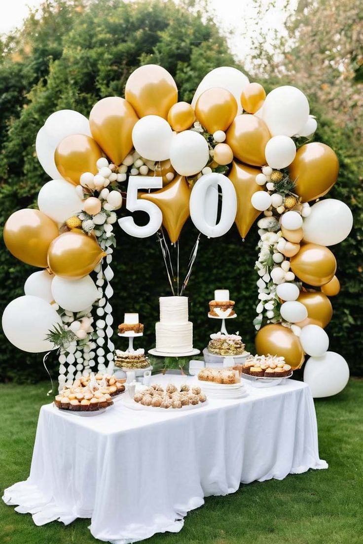 a table topped with lots of balloons and desserts