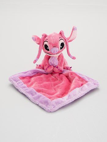 a pink and purple stuffed animal sitting on top of a blanket in the shape of an elephant