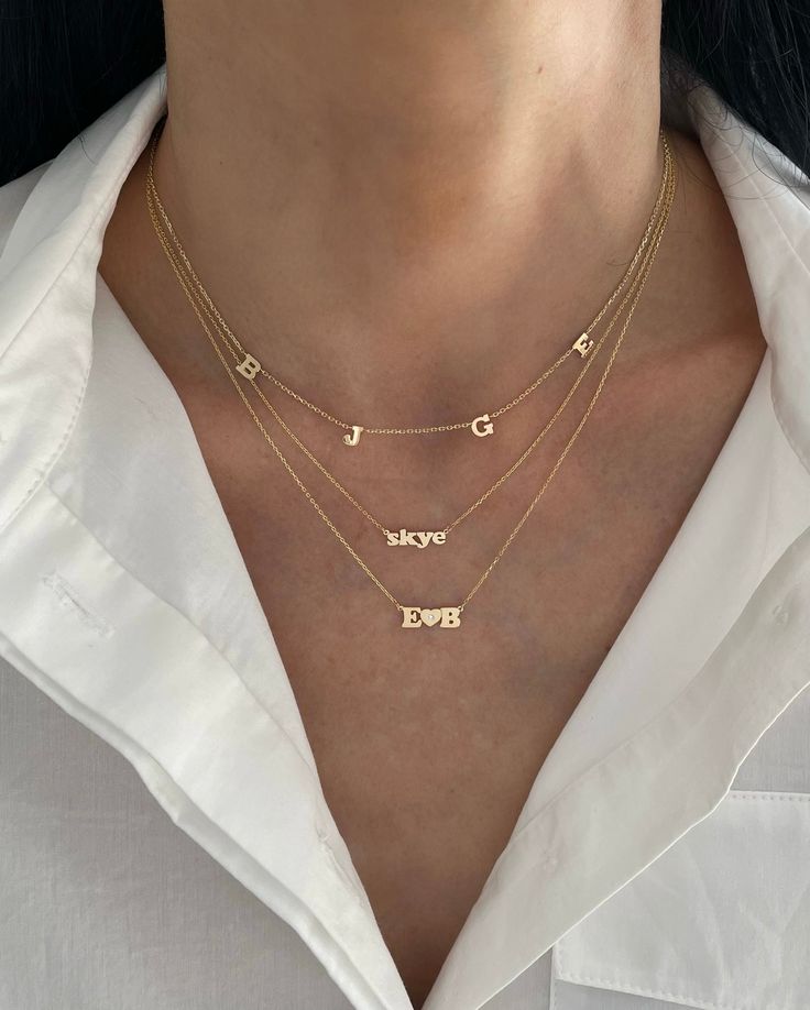 This 14K gold necklace with tiny letters spaced throughout the chain is the perfect addition to add to your personalized jewelry collection! SYMBOLS (heart or star) COUNT AS CHARACTERS. Available in 14K Yellow Gold or 14K White Gold Up to 7 characters total Character Measurement: Approx. 0.20" (varies slightly per letter and symbol) Uppercase letters only FINAL SALE Customized Necklace, Personalized Necklace Names, Squad Goals, 14k Gold Necklace, Upper Case, Mini Me, Jewelry Inspo, Personalized Necklace, Name Necklace