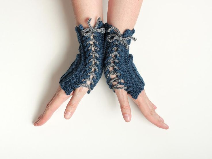 a pair of hands with knitted gloves on them