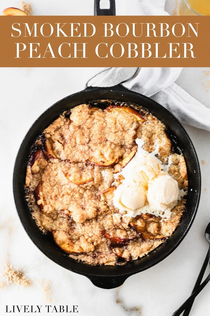 a skillet filled with peach cobbler and ice cream on top of a marble counter