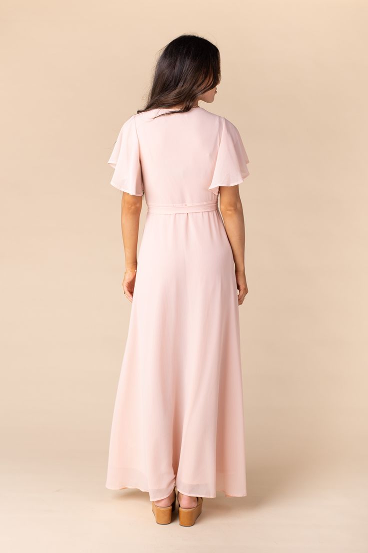 Flowing chiffon wrap maxi with tie belt Short flutter sleeves - lined to the cap sleeve length Self fabric tie belt Fully lined Fabric content - Polyester - Dry clean recommended Shop now at arborandco.com Modest Maxi, Blush Bridesmaids, Blush Bridesmaid Dresses, Chiffon Wrap, Shoulder Stretch, Peach Blush, Belted Shorts, Flattering Dresses, Chiffon Maxi