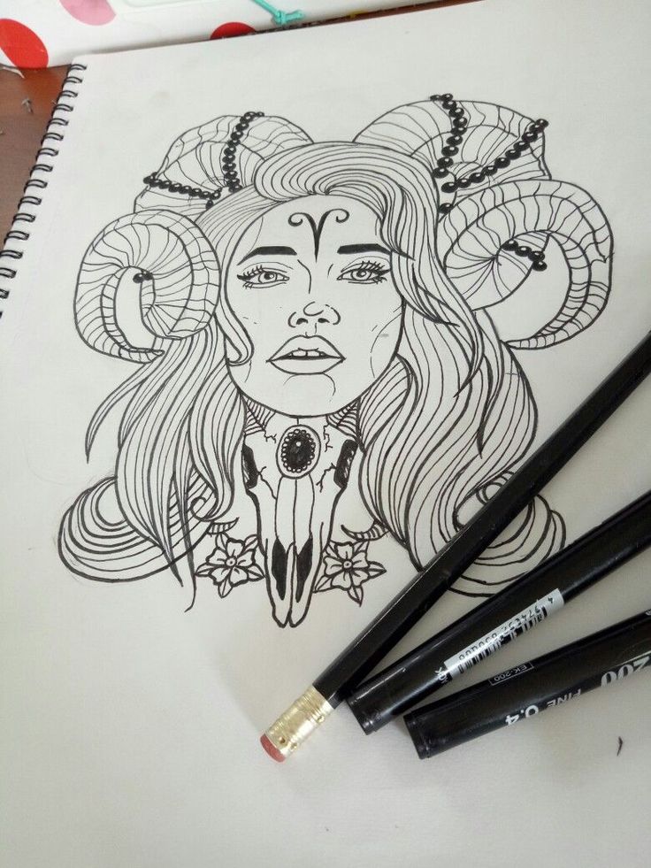 a drawing of a woman with horns on her head and three pencils next to it