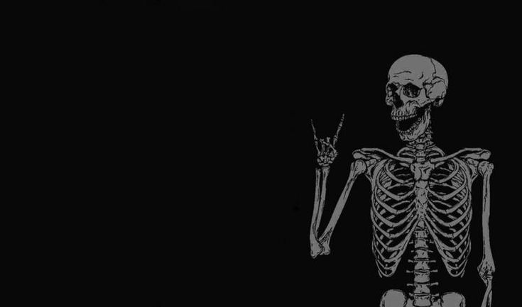 a skeleton holding a knife in the dark