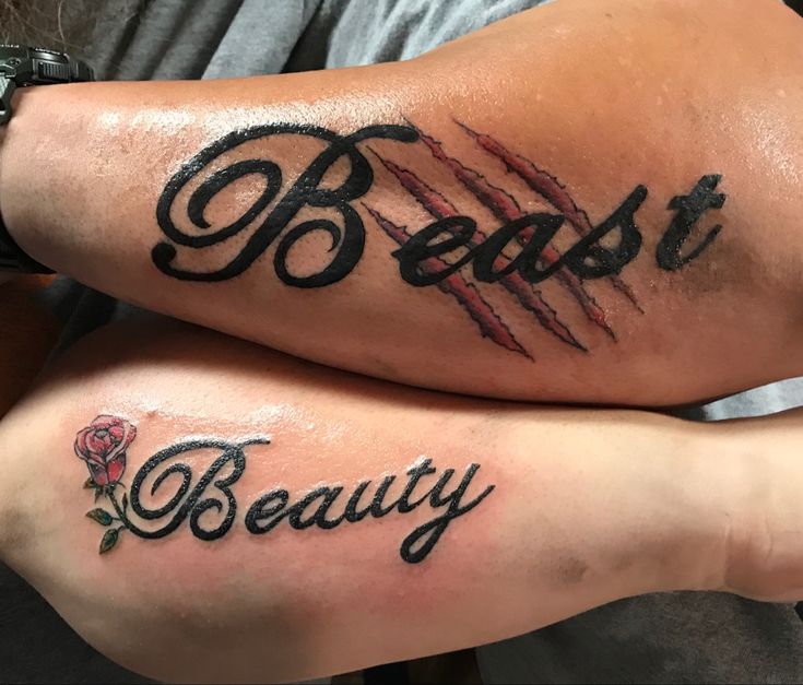 two people with tattoos on their legs that say beauty and beast, both have blood dripping from them