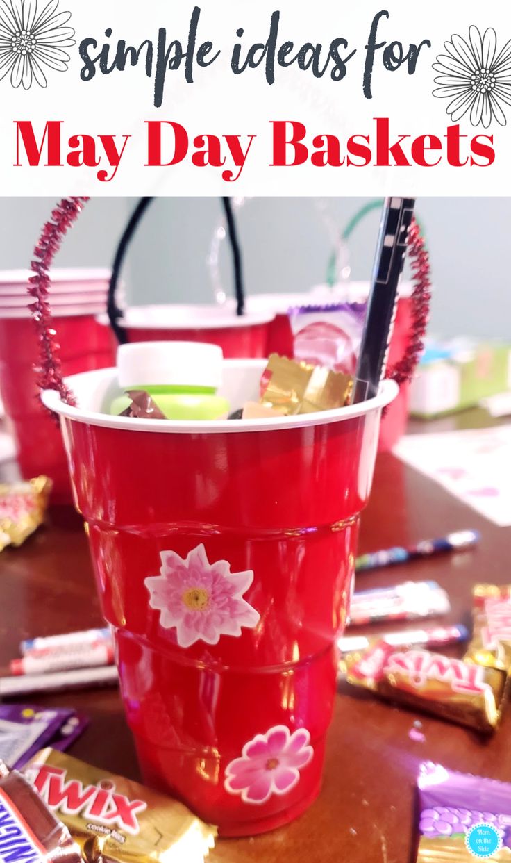 a red bucket filled with candy sitting on top of a table