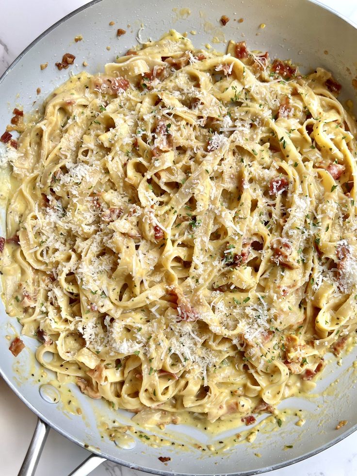 a pan filled with pasta covered in cheese and sauce