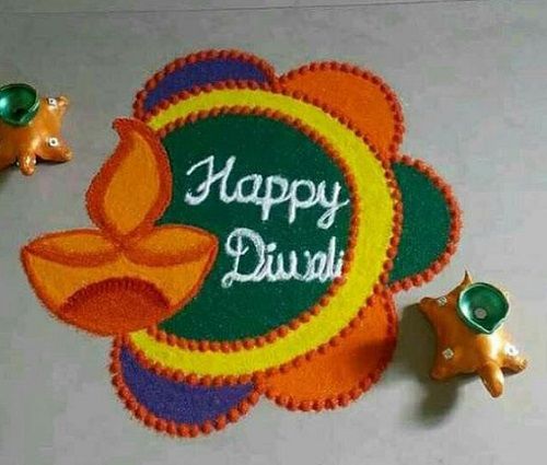 happy diwali with two small animals on the floor next to it and an orange flower