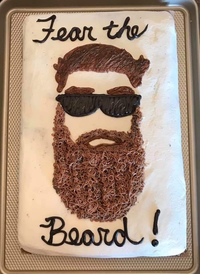 a cake that has been decorated to look like a man's beard and sunglasses