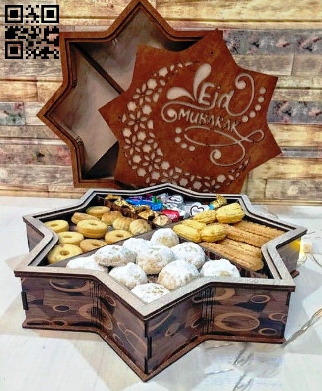 a wooden box filled with assorted pastries on top of a white tablecloth