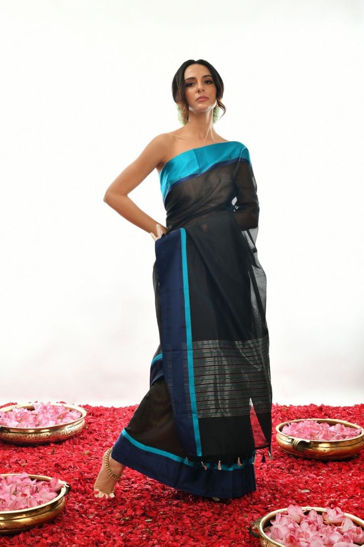 Crafted with care and expertise, this Handwoven Pure black Soft cotton by Kora Banarasi saree offers a unique look. Boasting a striking blue mashru silk border and a luxurious black color, this saree exudes a classy, elegant feel. Experience elegance and comfort like never before. Festive Black Pre-draped Saree With Self Design, Traditional Black Chanderi Saree, Black Pre-draped Saree For Festivals With Unstitched Blouse, Designer Black Tussar Silk Saree, Black Chanderi Traditional Wear, Black Dupatta With Zari Weaving For Designer Wear, Black Tussar Silk Traditional Wear, Black Tussar Silk Traditional Wear With Traditional Drape, Black Tussar Silk Dupatta With Traditional Drape