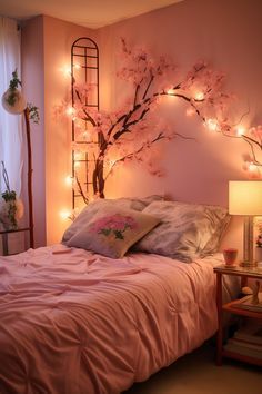 a bed with pink sheets and pillows next to a window covered in fairy lights that are hanging on the wall