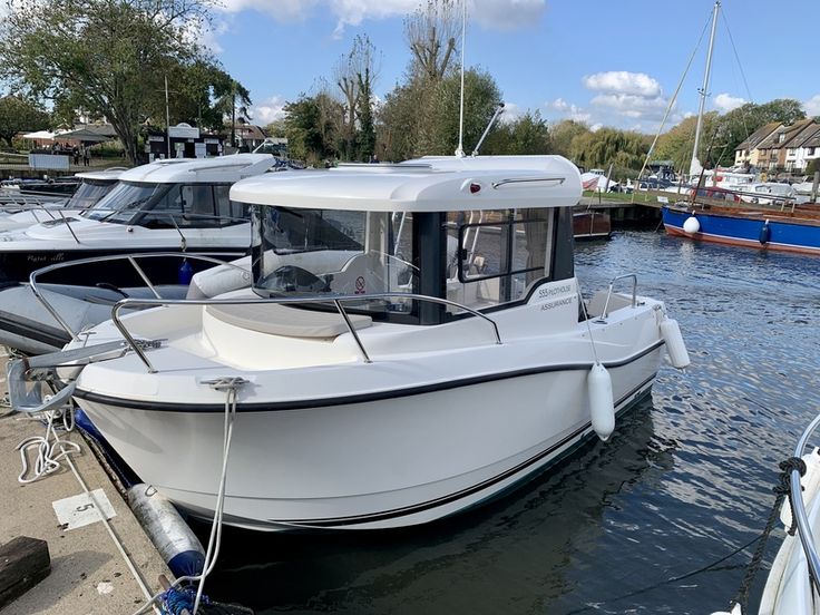 several boats are docked in the water near each other