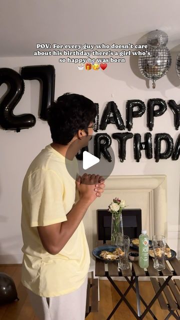 a man standing in front of a birthday cake with the words happy birthday on it