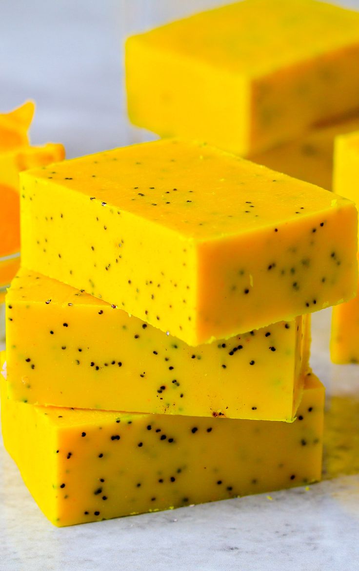 several pieces of yellow soap stacked on top of each other with black speckles