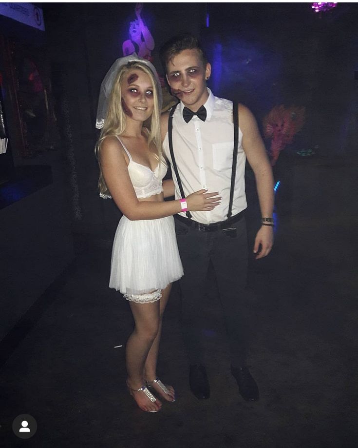 a young man and woman dressed up in formal wear posing for the camera at a party