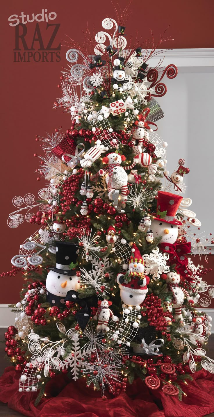 a christmas tree decorated with red, white and silver ornaments