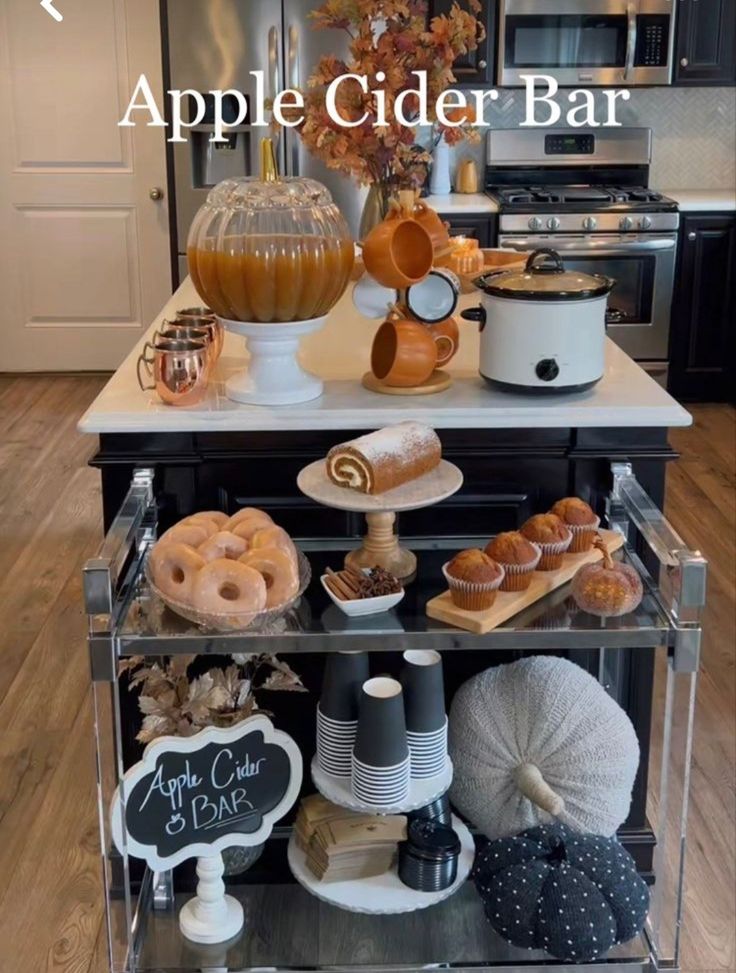 an apple cider bar with donuts, coffee cups and other items on it