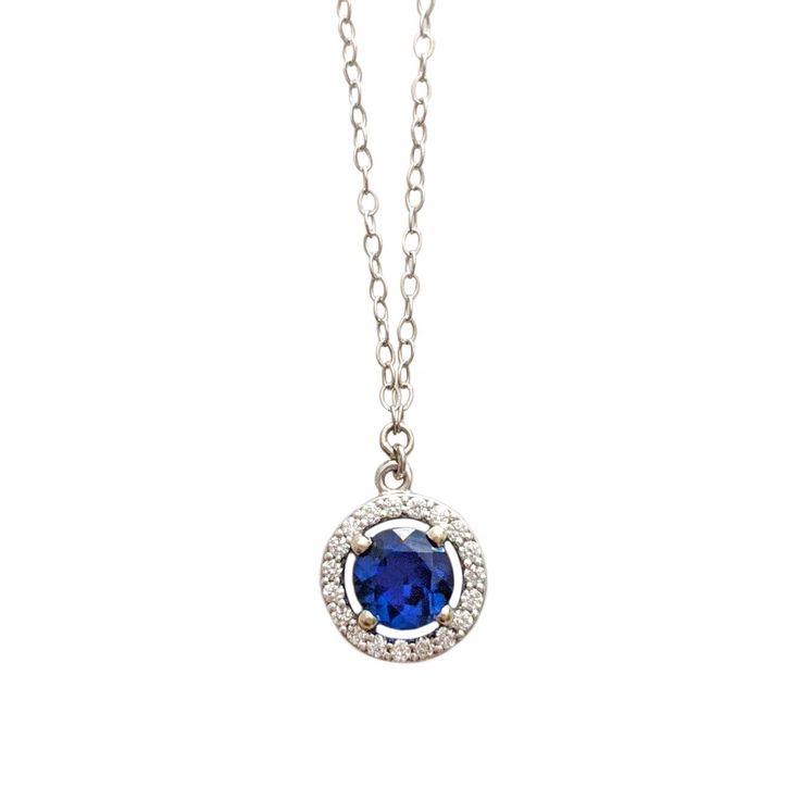 A gorgeous blue sapphire sparkles in the light, accented by a circle of diamonds. Set in 14k white gold, this is the prettiest sapphire necklace you may ever see! Handcrafted in 14k white gold Features a sapphire surrounded by a diamond halo Sapphire measures approx. 5.5mm in diameter Pendant measures approx. 10mm in diameter Full necklace hangs at 18" with a 14k lobster clasp Pastel Necklace, Jewel Design, True Summer, Blue Sapphire Pendant, Halo Necklace, Accesories Jewelry, Sapphire Pendant, Sapphire Necklace, A Circle