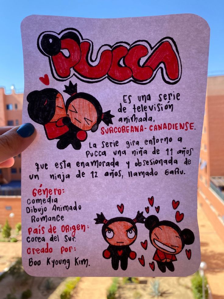 a hand holding up a piece of paper with cartoon characters on it and the words puca written in spanish