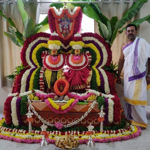 a man standing next to a large flower display