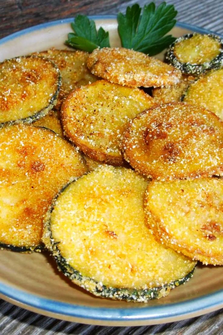 some fried food on a plate with parmesan sprinkles and garnish