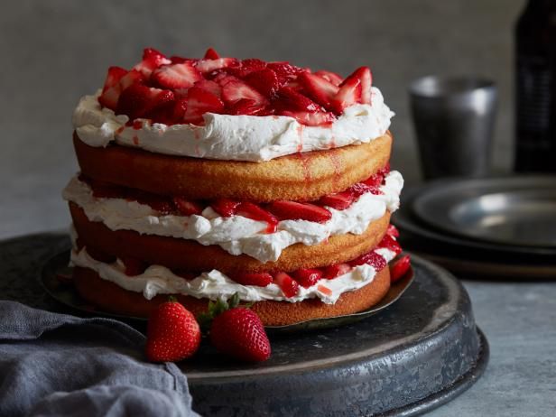 a cake with strawberries and whipped cream on top