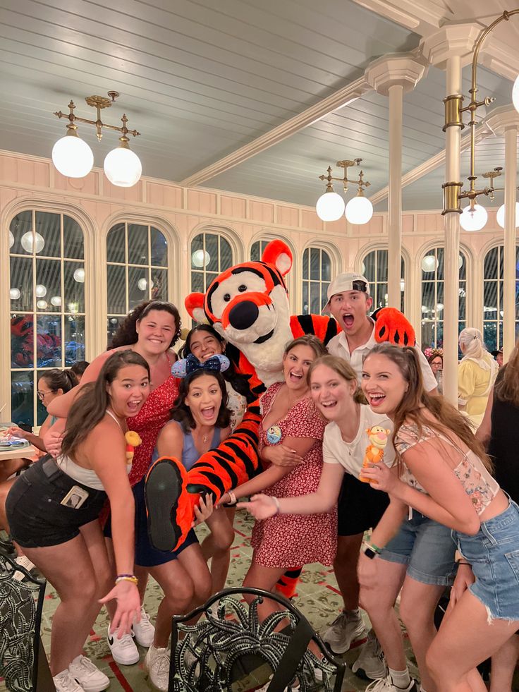 a group of people posing for a photo with the tigger