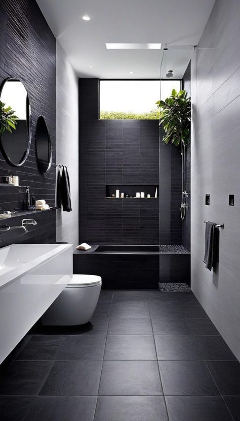 a black and white bathroom with two sinks, a toilet and a bathtub in it