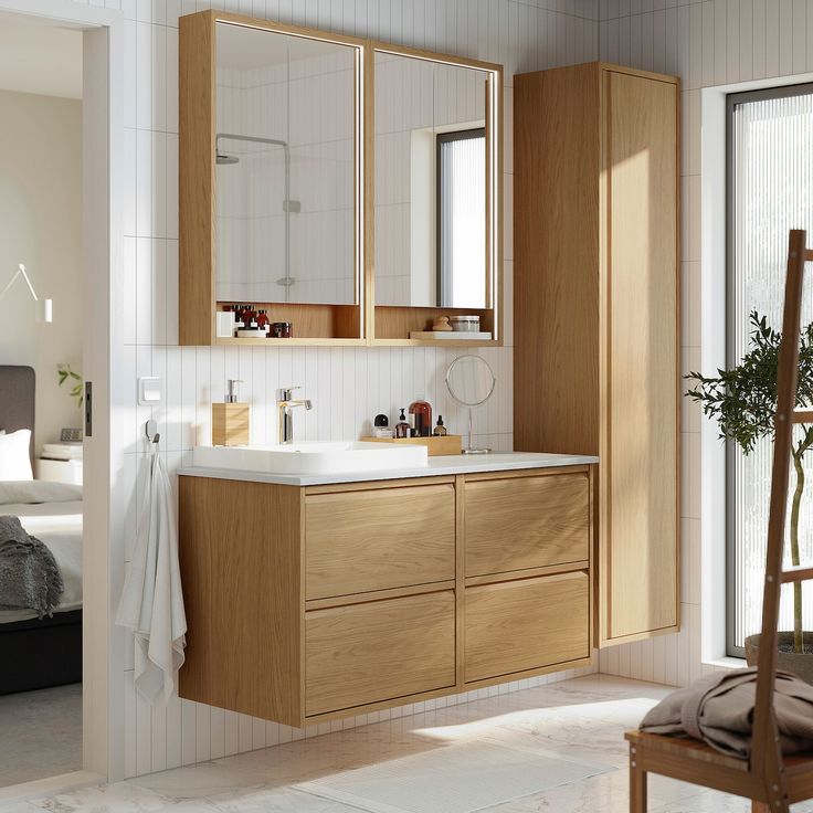 a bathroom with wooden cabinets and white walls