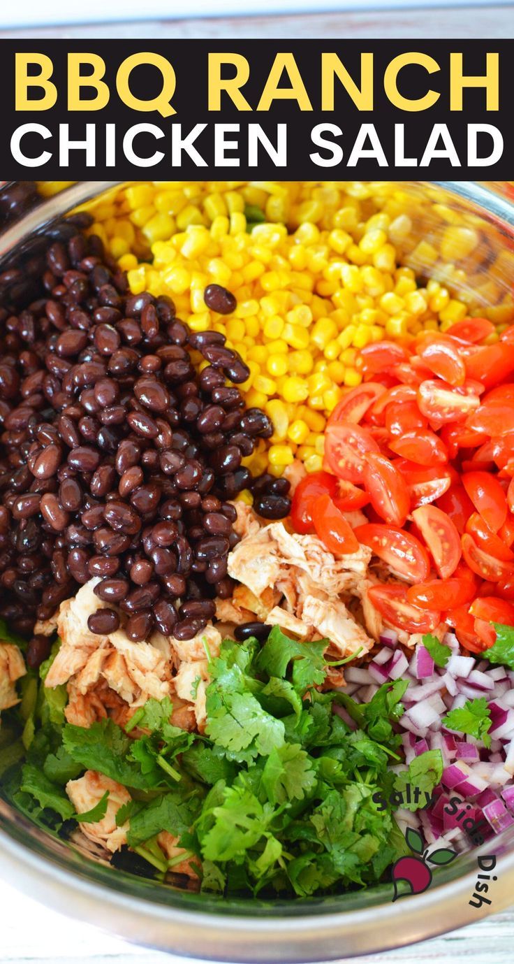 the bbq ranch chicken salad is in a bowl with lettuce, tomatoes, black beans, corn and cilantro