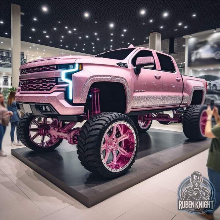 a pink truck is on display at a showroom while people are taking pictures behind it