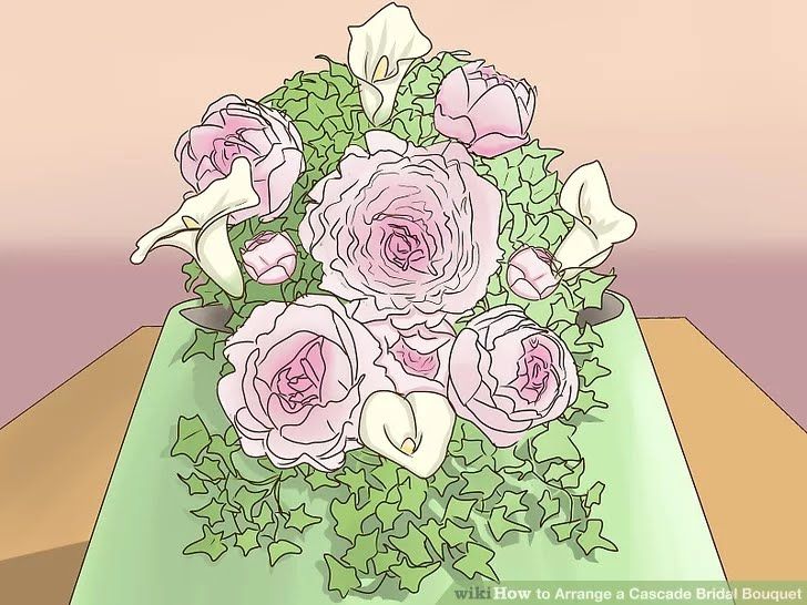 a vase filled with pink and white flowers on top of a green tablecloth covered table