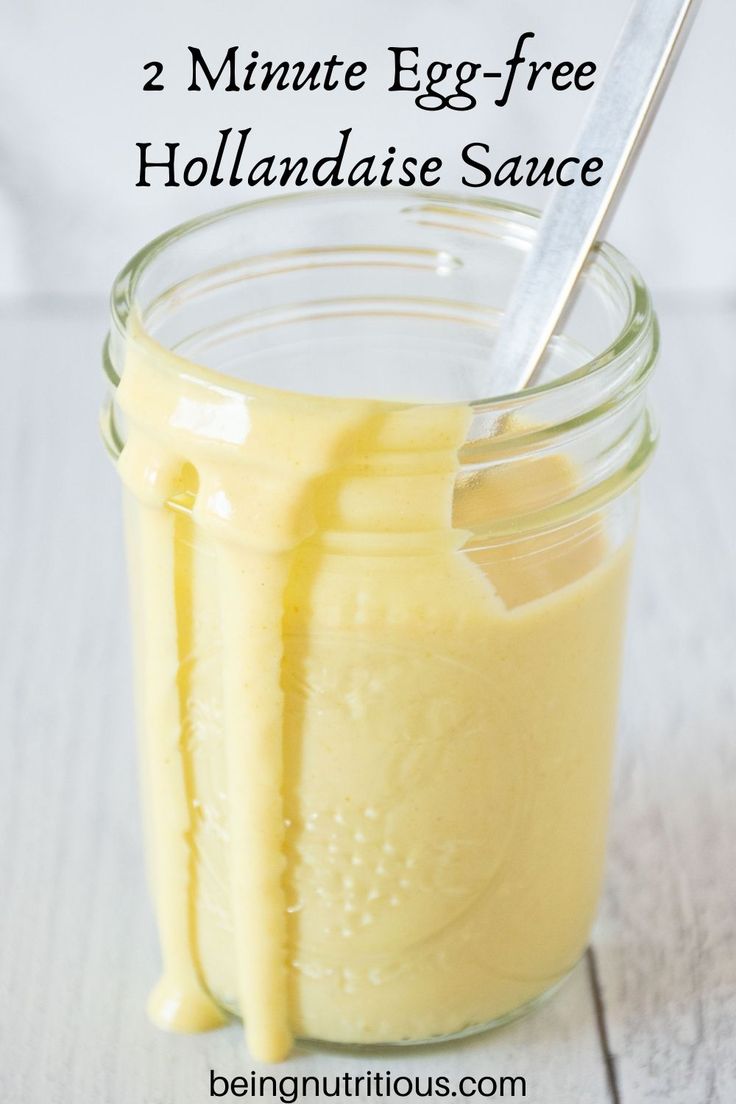 an egg - free hollandaise sauce in a glass jar with a spoon inside