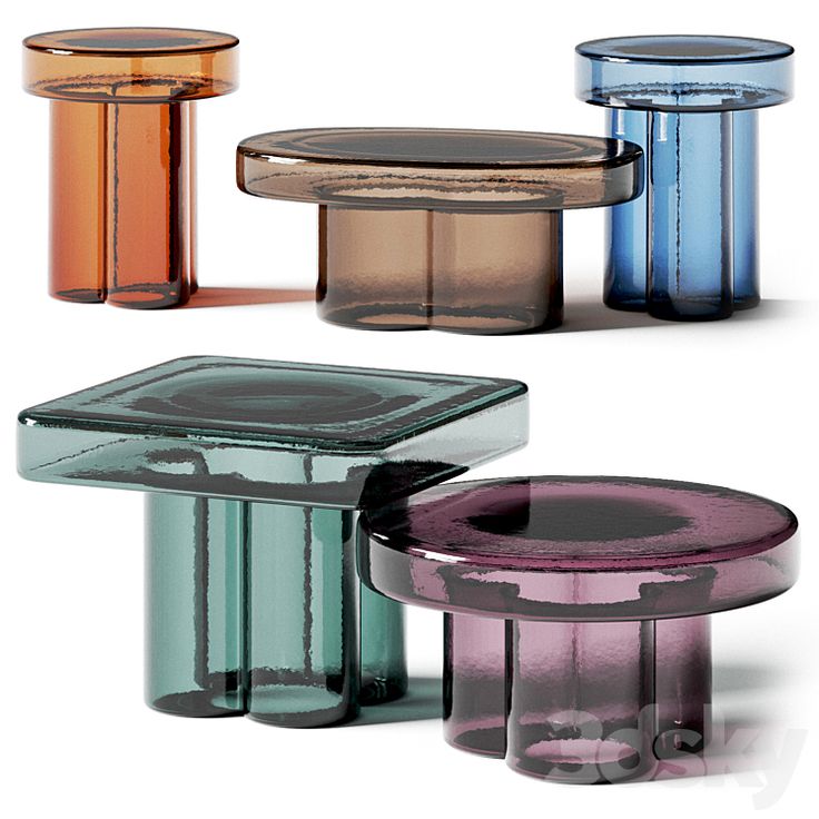 three different colored glass tables sitting next to each other