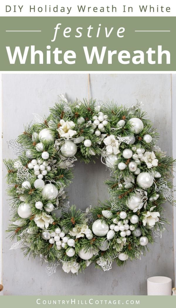 a white wreath hanging on the side of a door with text overlay that reads diy holiday wreath in white festive white wreath