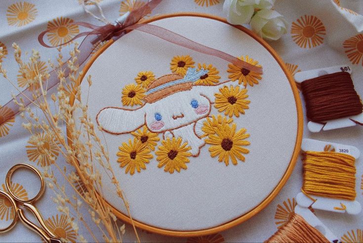 an embroidery project with sunflowers and scissors