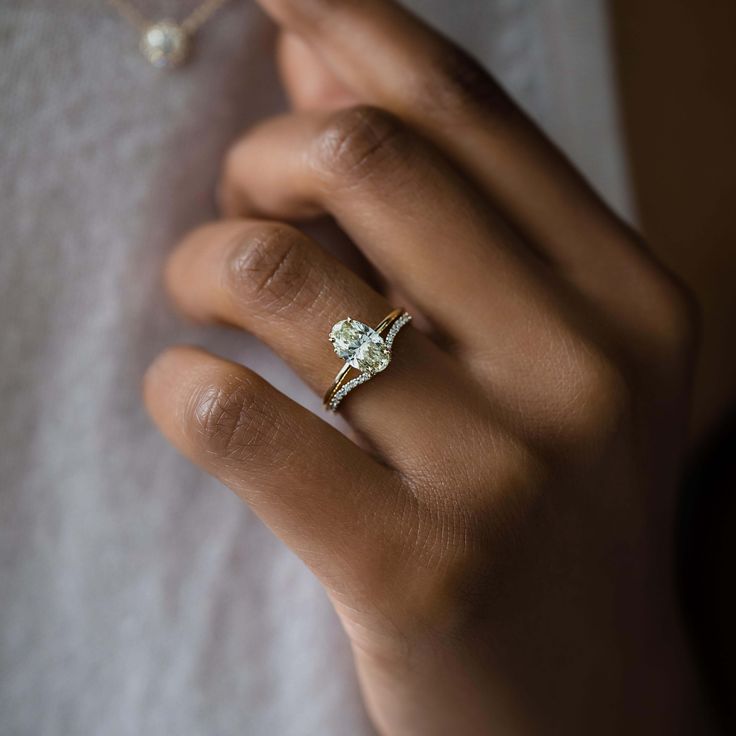 a woman's hand with a diamond ring on it