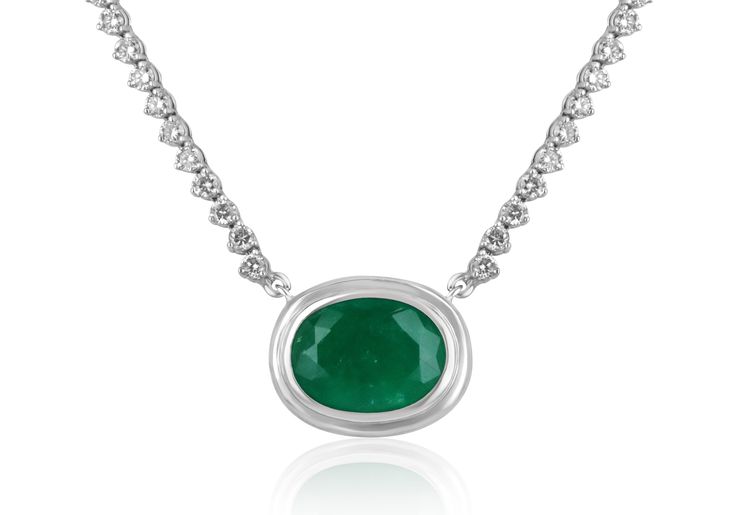 This necklace is not for the faint of heart! Featured here is a stunning oval Colombian emerald and diamond necklace made in fine 14K white gold. Displayed is a rich, dark green oval emerald with very good eye clarity for its huge 9.09-carat size. Brilliant round diamonds hug your neck with a sleek golden link chain that follows through the back.  Setting Style: Prong/ Bezel  Setting Material: 14k White Gold Stone: Colombian Emerald Shape: Oval Cut  Luster: Very Good Color: Dark Green Saturation: Dark Total Carat Weight: 9.09cts Measurements: 16.19 mm x 12.0 mm Eye Clarity: Translucent Origin: Colombia Treatment: Natural, Oiling Secondary Stone: Diamond Shape: Brilliant Round Weight: 1.74tcw Clarity: VS-SI Color: H-J Luster: Excellent Treatments: Natural If you have a special request for a Luxury Oval Necklaces For May Birthstone, Exquisite Oval Silver Emerald Necklace, Elegant White Gold Emerald Necklace In Oval Shape, Elegant White Gold Oval Emerald Necklace, Formal Oval Emerald Necklace In White Gold, Luxury Oval Emerald Necklace For May Birthstone, Formal White Gold Oval Emerald Necklace, Exquisite Oval Diamond Necklace Gift, Exquisite Oval Necklace With Single Cut Diamonds