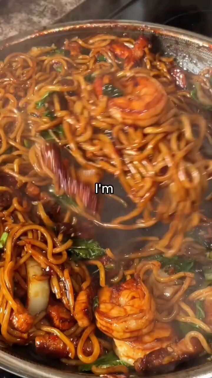 some noodles are being cooked in a pan