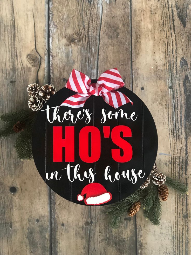 there's some ho's in this house sign with pine cones on it