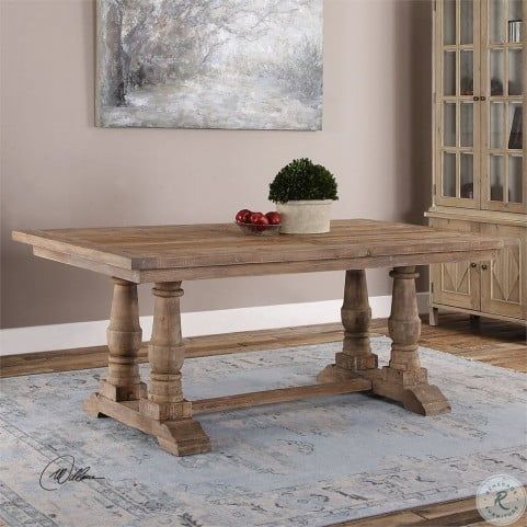 a wooden table sitting on top of a rug in a living room next to a painting