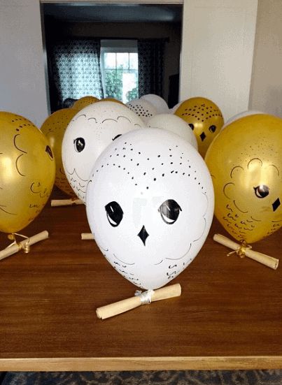 some yellow and white balls are sitting on a table with wooden sticks in front of them