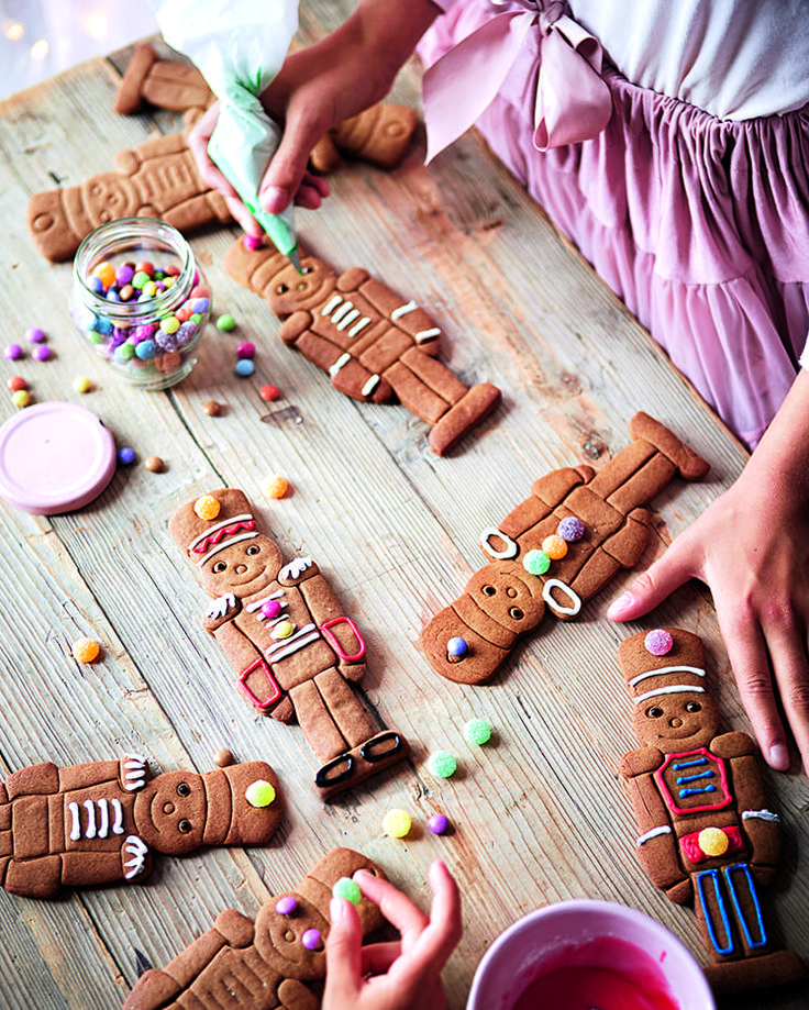 a table topped with lots of cut up gingerbreads