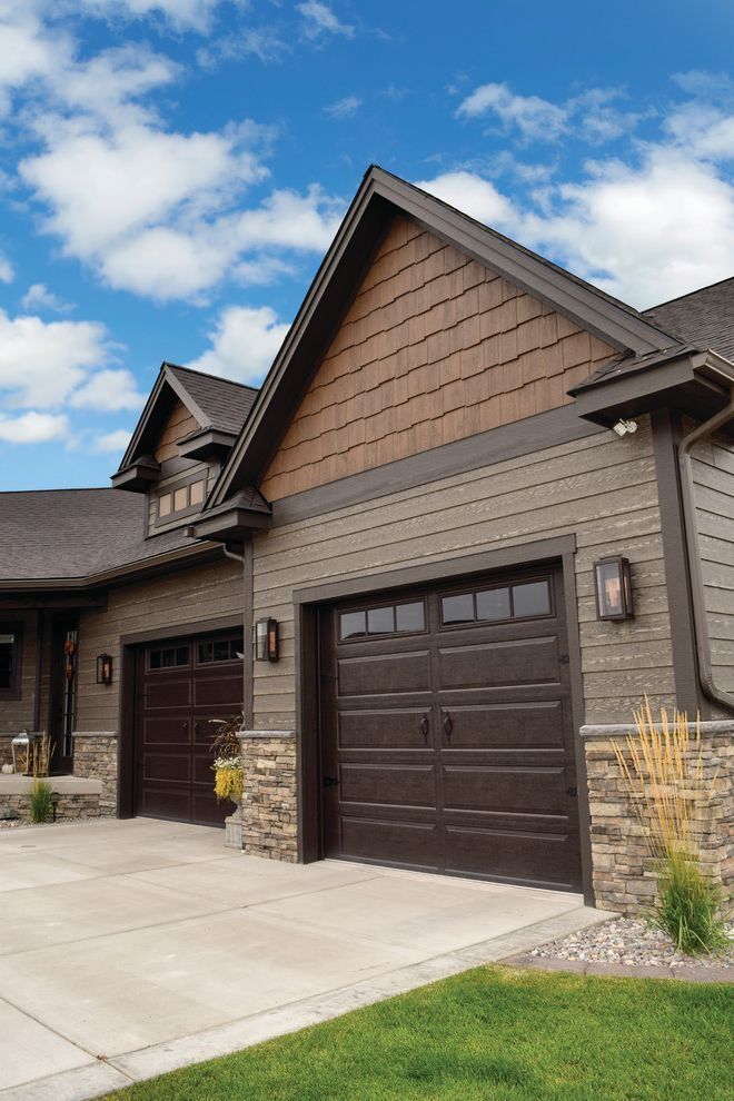 a large house with two garages on the front and one above it's door