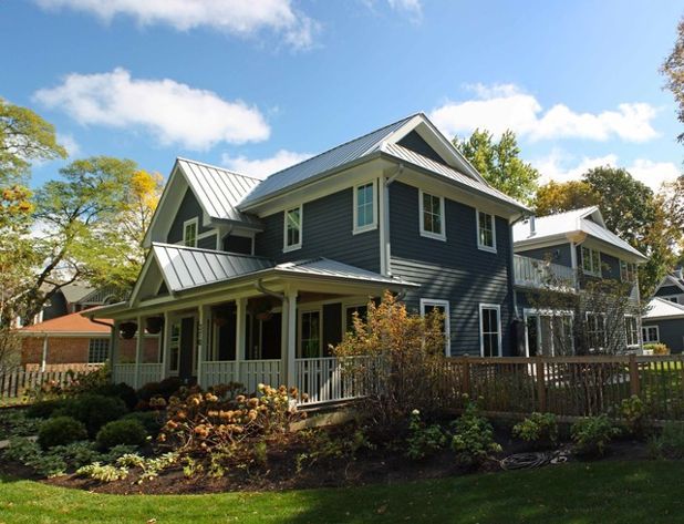 a blue house with white trim on the front and side of it's roof