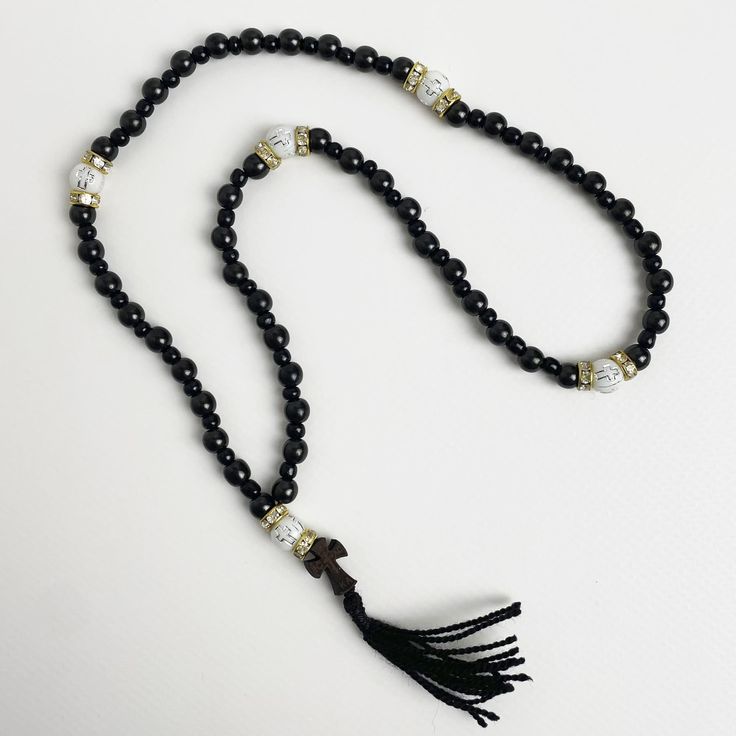 "50 beads rosary made of black jasper. The Orthodox prayer beads are crafted from the natural stone \"Gagat,\" renowned since ancient times for its protective and healing properties. It is alternatively known as \"Black Jasper\" or \"Black Amber.\" Splitting beads from the wood species \"Boxwood\" - which is one of the hardest wood species. Orthodox black rosary will be an amulet and protector of its owner, used for counting the prayers read or other ritual actions, preserving attention and concentration, the task of rhythm, massage nerve endings located on the fingertips, associated with the nervous system of man.  ★ Length of the rosary: 13.78 in (35 cm) ★ Bead diameter: 0.23~0.11 in (6~3 mm) ★ Number of beads: 50+5 pcs (50 gagat beads, 5 boxwood beads) ★ Dimensions of the cross: 0.69 in Black Wooden Beads Rosary Spiritual Style, Black Wooden Beads Rosary, Black Wooden Beads Spiritual Rosary, Adjustable Black Rosary With 8mm Beads, Black Spiritual Beaded Necklaces With Polished Beads, Hand-strung Black Mala With Round Beads, Spiritual Black Beaded Necklace With Gemstones, Black Gemstone Beads Mala For Healing, Black Mala With 8mm Beads For Healing