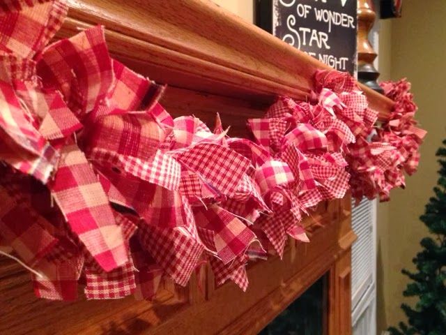 a red and white checkered bow is hanging on the mantle