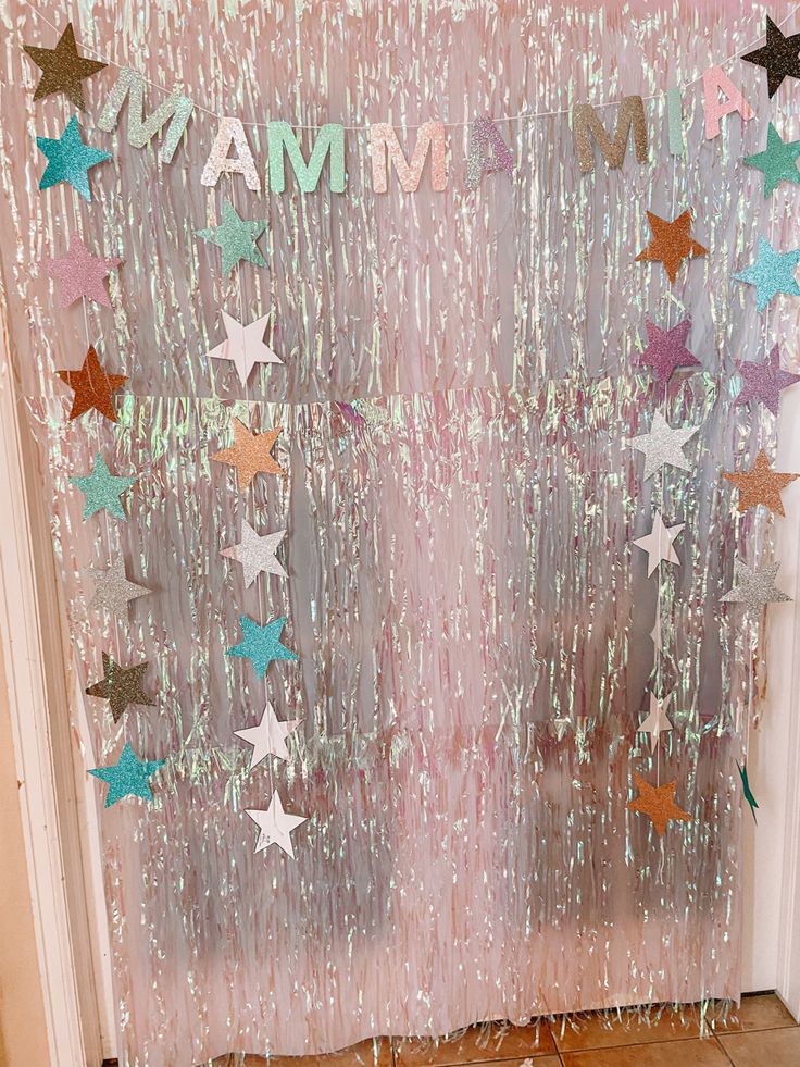 a door decorated with stars and the word mam on it's glass curtain